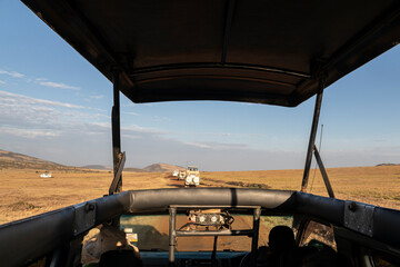 jeep trip on savanna road, safari in masai mara park, kenya, africa