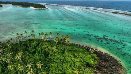 Aerial view of a tropical island surrounded by the beautiful Pacific Ocean and vibrant reef, Rarotonga, Cook Islands.