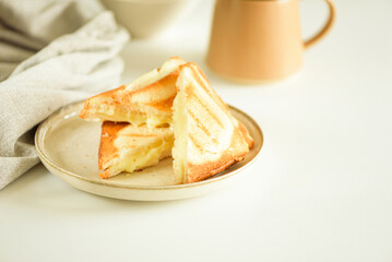 Pieces of melted cheese sandwich on white table