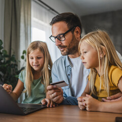 Father and daughters have online shopping on laptop with credit card