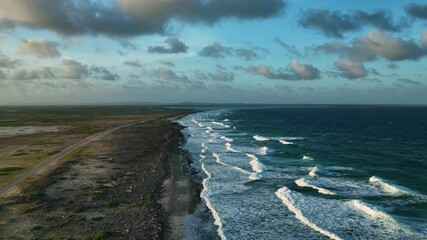 Aerial view of beautiful tropical reef and serene sandy beach with waves, Caribbean, Netherlands.