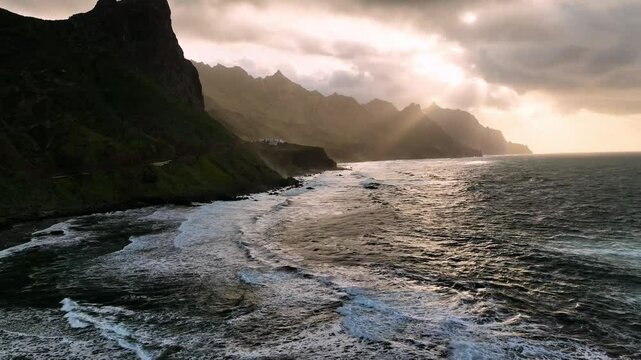 Aerial view of rugged cliffs and crashing waves along the coastline, Santa Cruz de Tenerife, Spain.