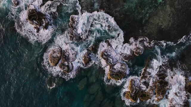 Aerial view of vibrant tropical island reef with azure ocean waves and rugged rocks, Tongatapu, Tonga.