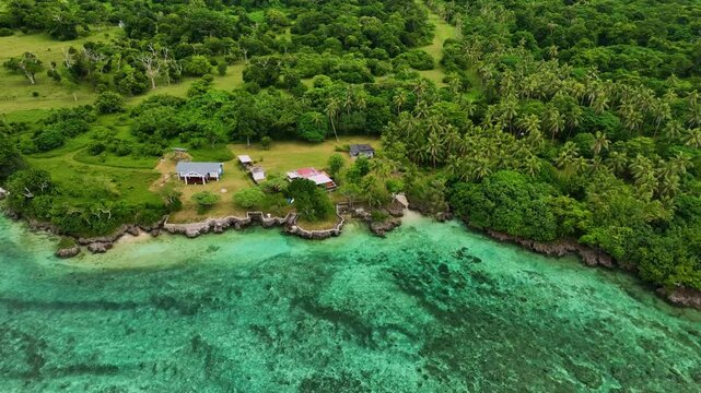 Aerial view of a beautiful tropical island with lush greenery, turquoise waters, and serene waves, Shefa Province, Vanuatu.