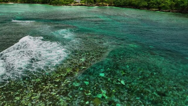 Aerial view of abstract reef with waves in crystal clear turquoise water, Shefa Province, Vanuatu.