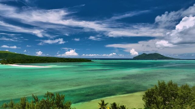 Aerial view of tropical island with vibrant coral reef and crystal clear ocean waves under serene clouds, Shefa Province, Vanuatu.