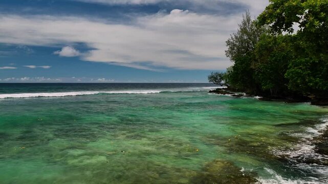 Aerial view of a tropical island with pristine beach, azure ocean, and lush palms, Shefa Province, Vanuatu.
