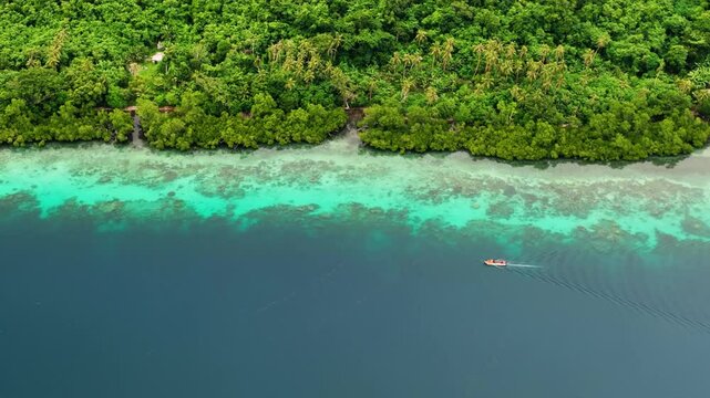Aerial view of a tropical paradise island with turquoise water, lush greenery, and a serene lagoon, Shefa Province, Vanuatu.