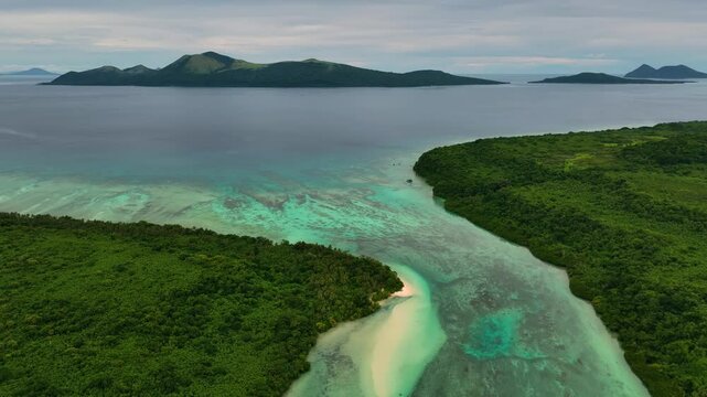 Aerial view of a tropical paradise island with a serene lagoon and lush greenery, Shefa Province, Vanuatu.
