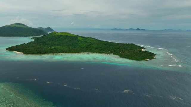 Aerial view of a beautiful tropical island with a pristine lagoon and lush palms, Shefa Province, Vanuatu.