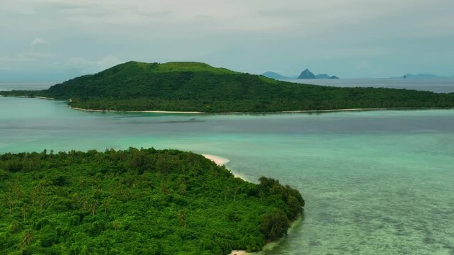 Aerial view of tropical islands with vibrant greenery and pristine coral reefs, Shefa Province, Vanuatu.