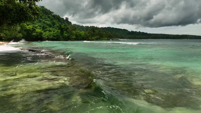 Aerial view of tropical island with pristine beach, azure ocean, and lush palms, Shefa Province, Vanuatu.