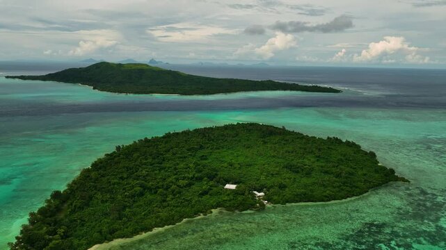 Aerial view of a beautiful tropical island with a serene lagoon and lush palms, Shefa Province, Vanuatu.