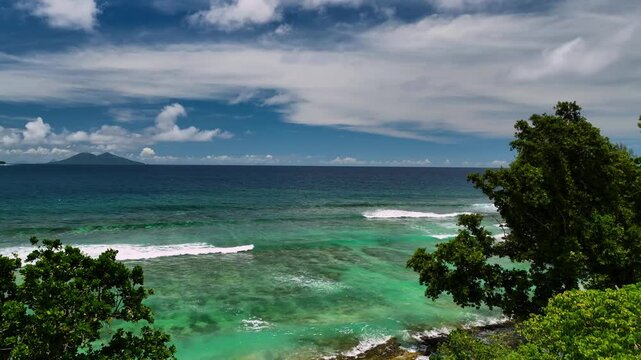 Aerial view of a beautiful tropical island with turquoise waters, clear skies, and palm trees, Shefa Province, Vanuatu.