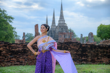 Caucasian girl wearing Thai traditional dress visiting the world heritage site