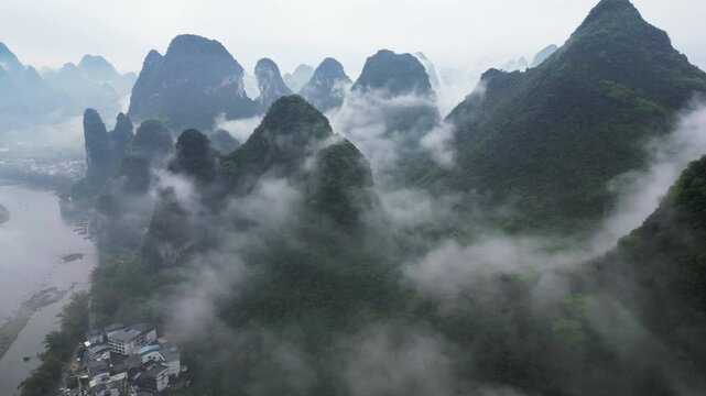Aerial view of misty karst mountains with clouds and scenic landscape, Guilin, China.