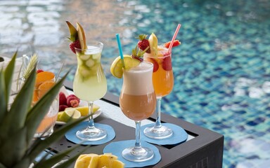 Tropical Cocktails with Fruit Garnishes by the Poolside, Perfect for a Summer Party
