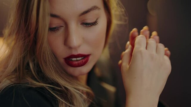 Close-up portrait of a woman with red lips and blonde hair, showing elegance and confidence. The image captures her beauty and style. Portrait Of Fashionable Young Beautiful Woman with Red Lips.