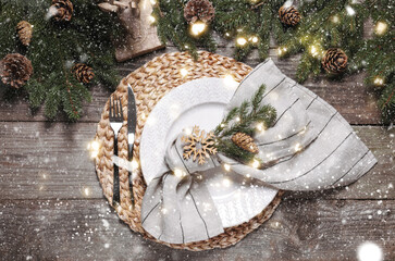 Luxury place setting with beautiful festive decor for Christmas dinner on wooden table, flat lay. Bokeh effect