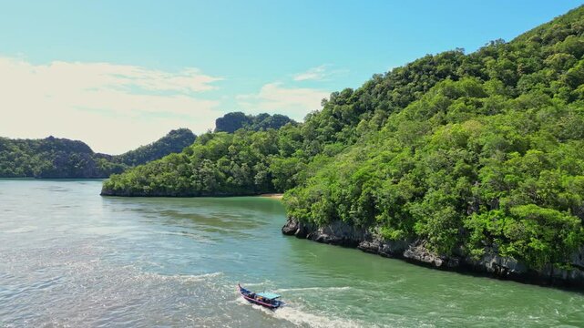 Aerial view of lush green hills and pristine ocean in a tropical paradise, Tanjung Rhu, Malaysia.