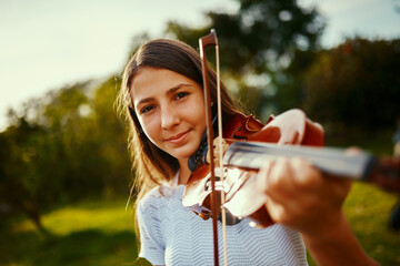 Girl, violin and portrait in nature for music, talent and entertainment for event. Musician, string...