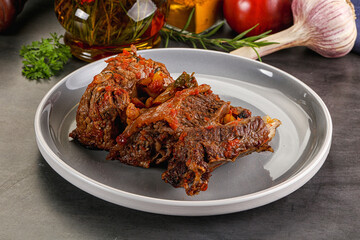 Baked beef ribs with vegetables