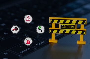 The caution sign, surrounded by symbols representing online threats, serves as a stark warning of...
