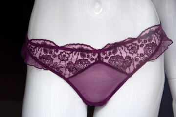 Closeup of purple cheeky on mannequin in a fashion store showroom