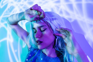Futuristic woman exploring virtual reality in colorful lighting