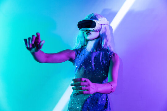 Futuristic woman exploring the metaverse in neon lighting