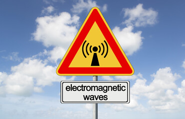 ALERT ABOUT ELECTROMAGNETIC POLLUTION EXPOSURE - Concept with warning indicator sign against a cloudy sky