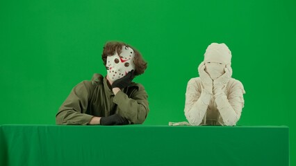 Portrait of person in a mummy bandage on chroma key green screen background. Mummy and maniac...