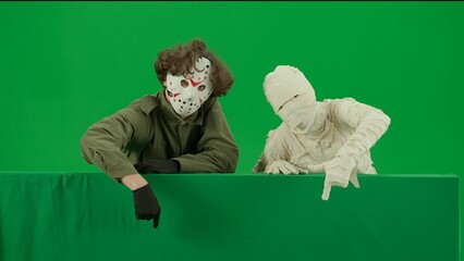 Portrait of person in a mummy bandage on chroma key green screen background. Mummy and maniac...