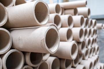 Close up view of stack of cylindrical cardboard tubes.