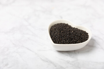 Basil seeds on textured wooden background. Close-up. Superfood. Ocimum basilicum. Organic basil seeds. selasih. Space for text. Copy space.