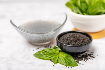 Basil seeds on textured wooden background. Close-up. Superfood. Ocimum basilicum. Organic basil seeds. selasih. Space for text. Copy space.