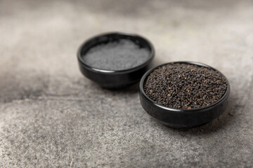Basil seeds on textured wooden background. Close-up. Superfood. Ocimum basilicum. Organic basil seeds. selasih. Space for text. Copy space.