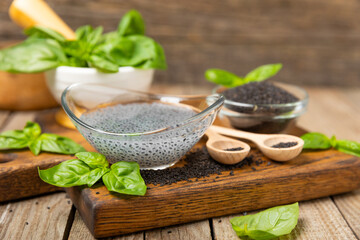 Basil water and basil seeds on textured wooden background. Close-up. Superfood. Ocimum basilicum....