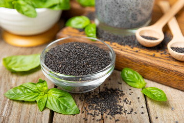 Basil seeds on textured wooden background. Close-up. Superfood. Ocimum basilicum. Organic basil seeds. selasih. Space for text. Copy space.