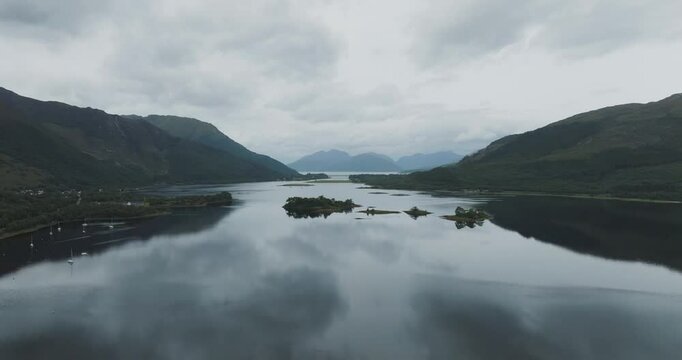 Aerial view of serene Loch Leven surrounded by majestic mountains and tranquil water, Glencoe, United Kingdom.