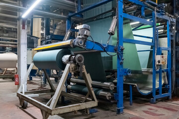Fototapeta premium Fabric batching process machine industrial plant line in a textile factory.