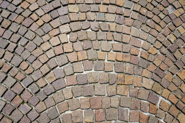 Fan-shaped pavement made of square natural granite cobble stones, pattern spreading out in fan form