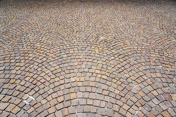 Fan-shaped pavement made of square natural granite cobble stones, pattern spreading out in fan form