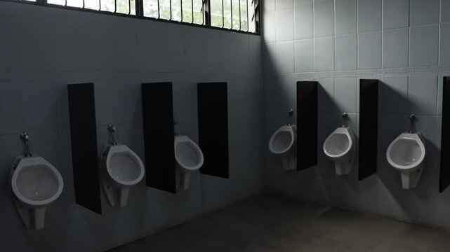 Urinals in mens bathroom on sunny day