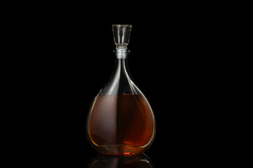 Bottle of whiskey isolated on black background.