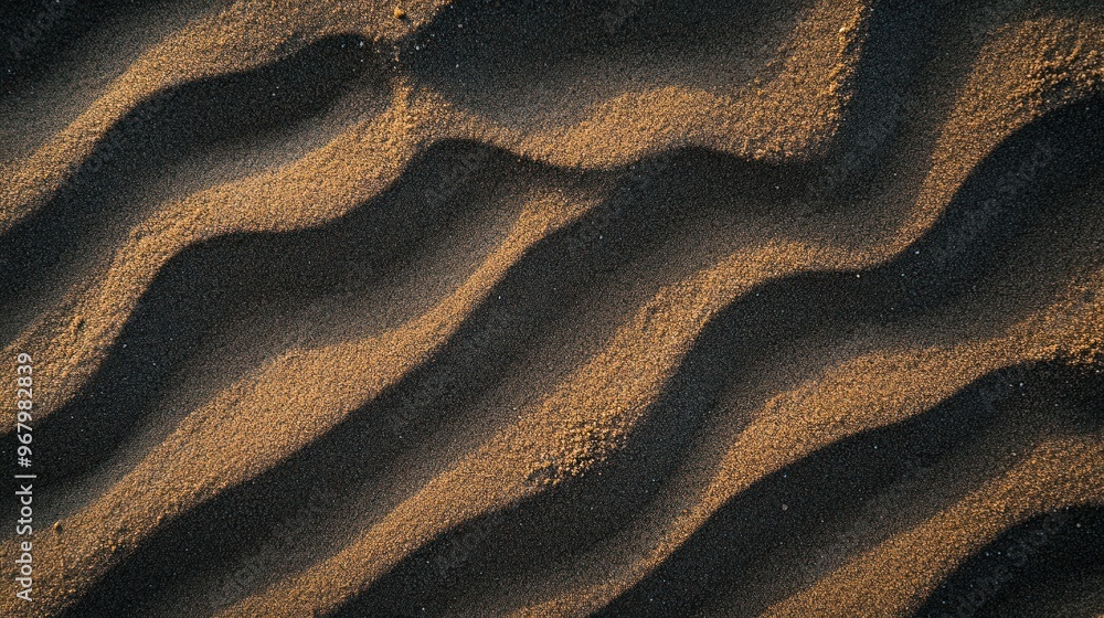 Poster close-up of textured sand with gentle waves and patterns created by wind.