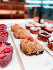 Croissants and pastries in the window of a coffee shop. Stand with croissants in a store. Concept of croissants and pastries