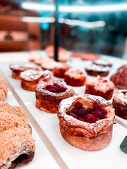 Croissants and pastries in the window of a coffee shop. Stand with croissants in a store. Concept of croissants and pastries