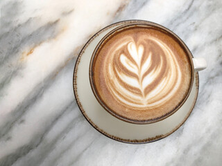 cappuccino coffee with latte art on marble table with copy space