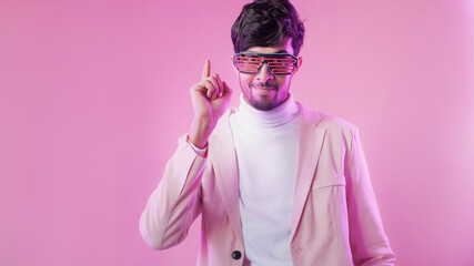 Party idea. Creative insight. Aha moment. Purple color neon light inspired man in glasses pointing...